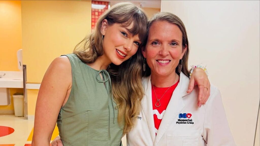 Hospital staff smiling with Taylor Swift during her surprise visit showing appreciation for her kindness